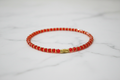 Chaîne de cheville rouge & or – fond marbre